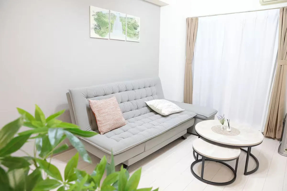 Location 02: neutral furnished room with sofa and open floor space