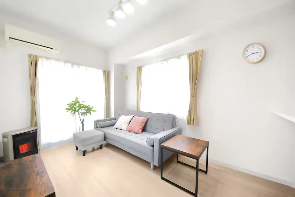 Bright furnished interior with a sofa and table at Location 03