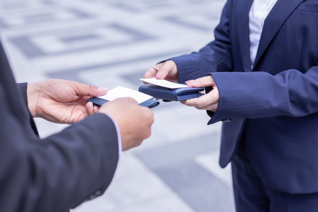 Two persons exchanging business cards in Japan